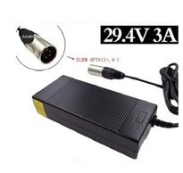 Black rectangular laptop power adapter with attached cord and a round barrel DC plug; label shows 29.4V 3A
